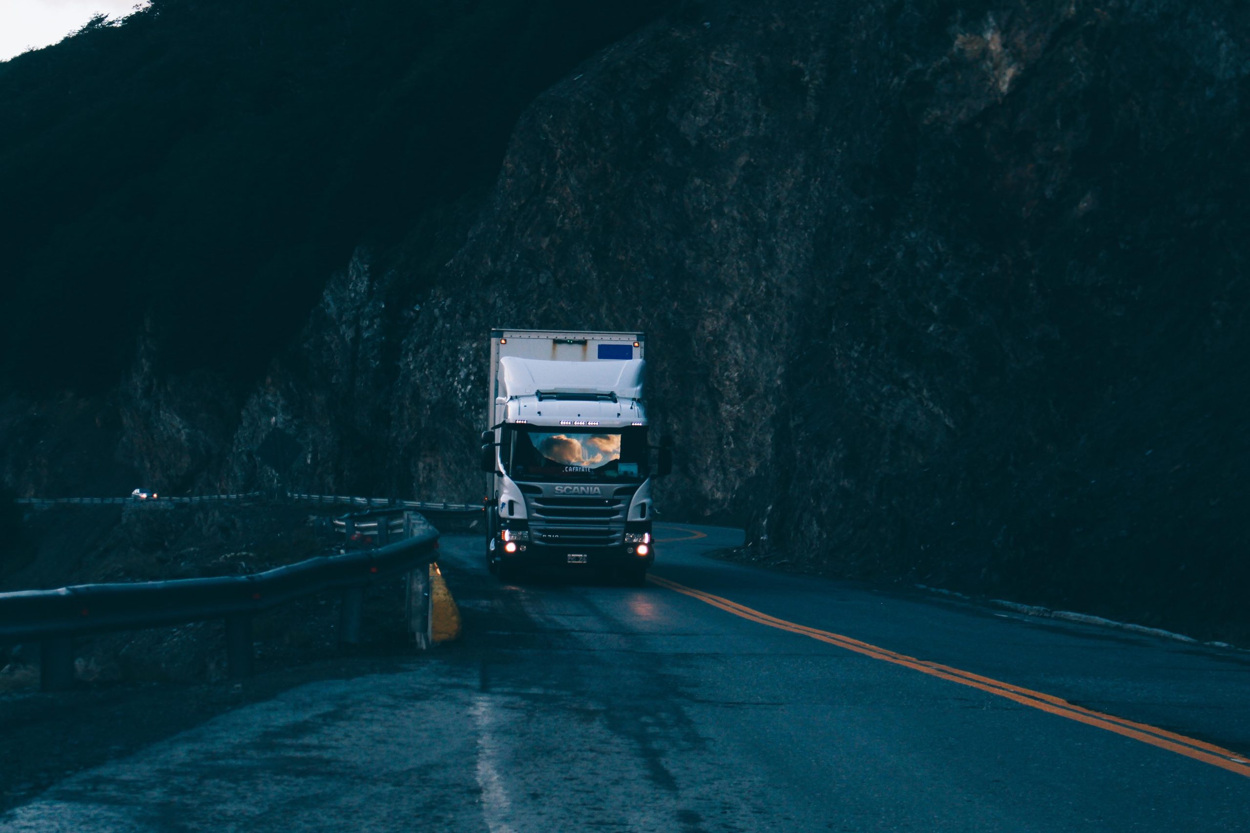 A commercial truck driving along a mountain road in Ontario.
